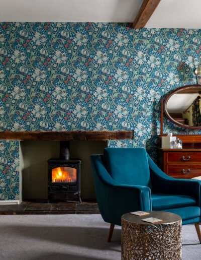St Johns House Garden Room fireplace and chair