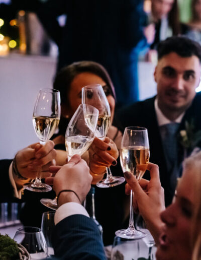 Party group toasting with champagne at the table