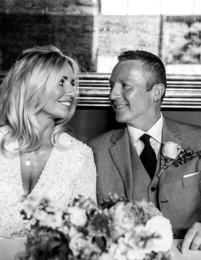 Black and white image of bride and groom looking into each other's eyes at St Johns House in Lichfield