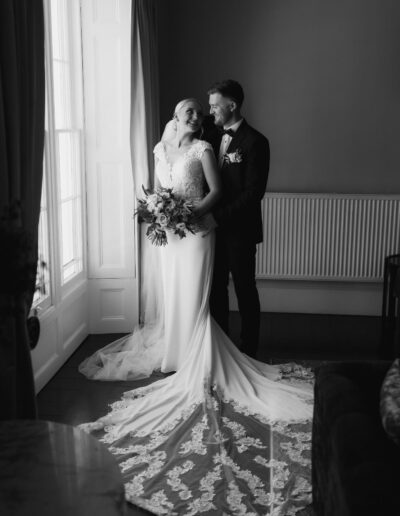 Bride and groom in the window at St Johns House in Lichfield