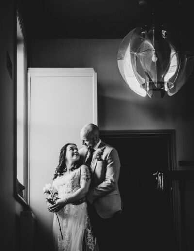 Bride and groom in the window at St Johns House in Lichfield