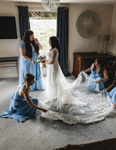 Bridal party getting a bride's dress ready at St Johns House in Lichfield