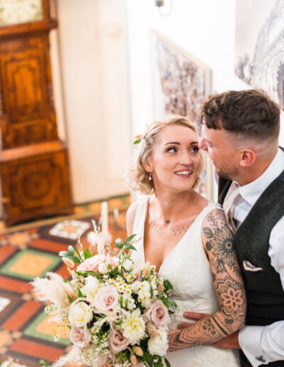 Bride and groom looking at each other on the stairs of St Johns House in Lichfield