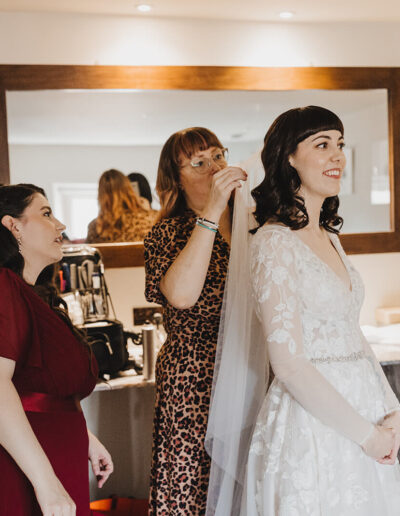 Bridal party attaching a brides veil