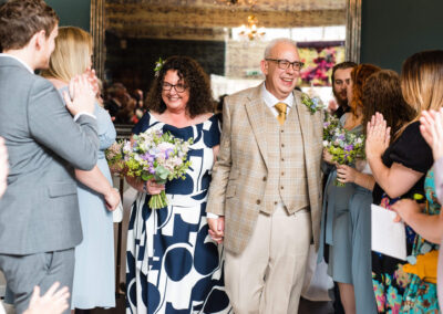 Bride and groom leaving their wedding ceremony at St Johns House in Lichfield