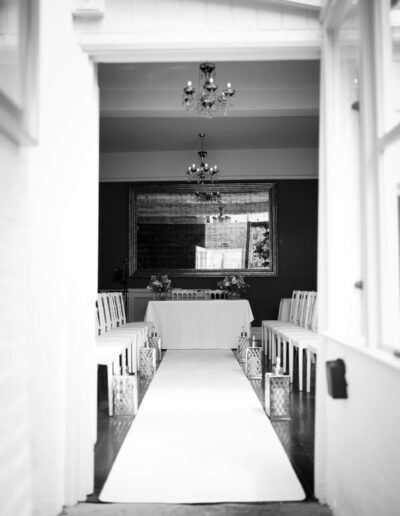 black and white image of the ceremony room at St Johns House in Lichfield through a doorway
