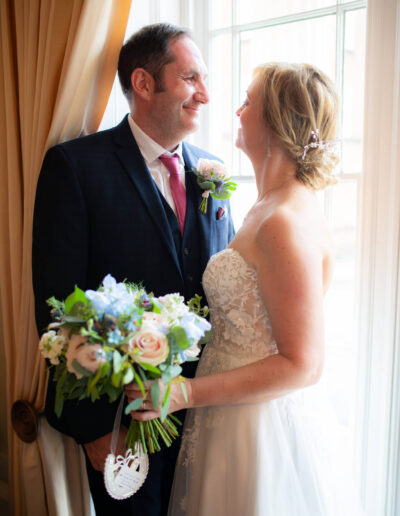 bride and groom in window of St Johns House in Lichfield