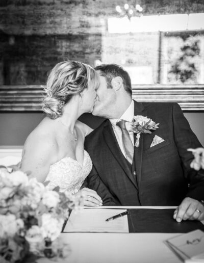 Black and white image of bride and groom at a table at St Johns House in Lichfield