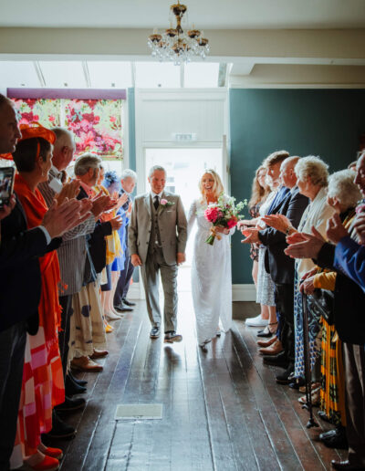Bride and groom walking down the aisle at St Johns House in Lichfield