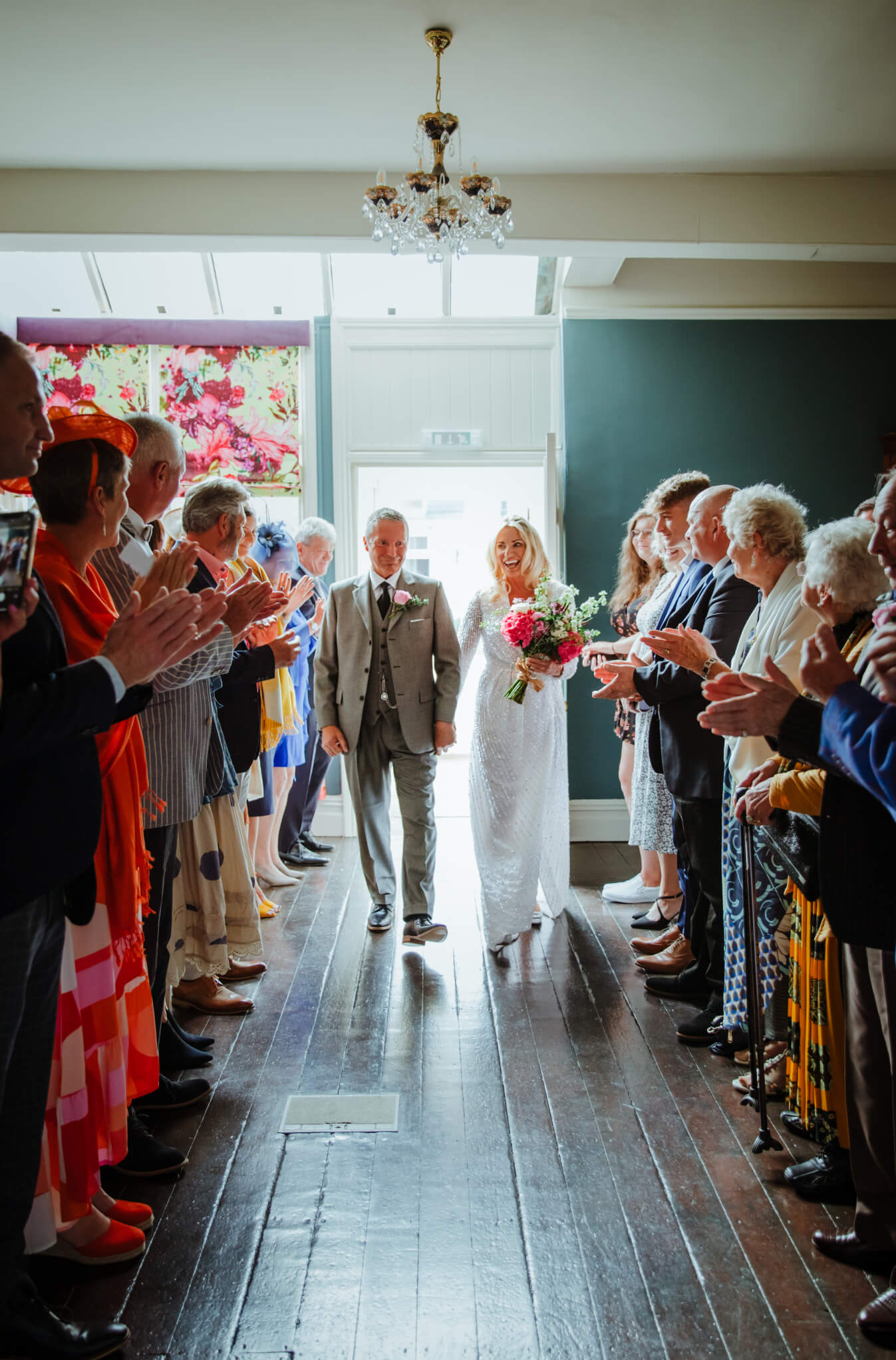 Bride and groom walking down the aisle at St Johns House in Lichfield